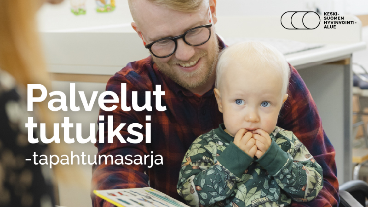 Miehellä lapsi sylissä.